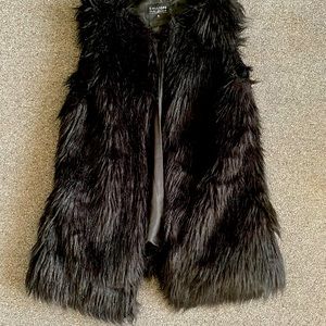 Black faux fur vest.